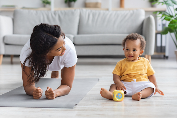 Sport At Home. Young Black Mom Making Plank Exercise With Little Baby
