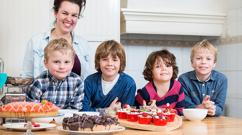 Image of mum and 4 boys in mess free kitchen cake decorating