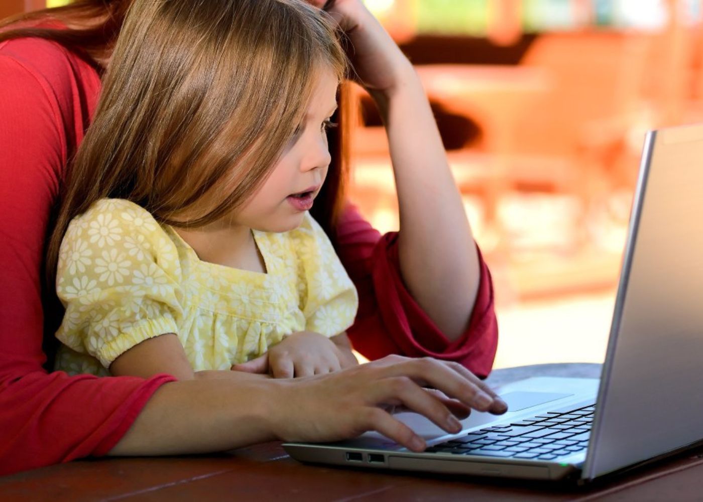 A busy working mum juggling work from home with her child